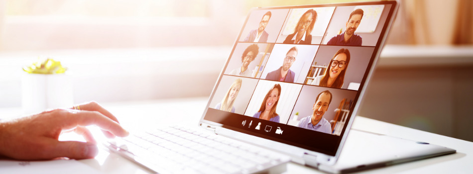 Laptop screen with a video meeting grid.