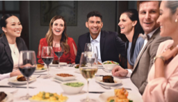 People sitting around a table, socializing and eating