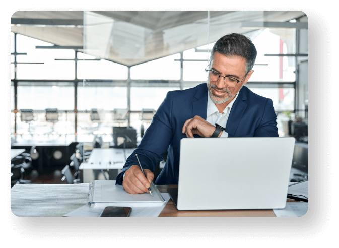 Photo of man validating data on laptop in office environment.