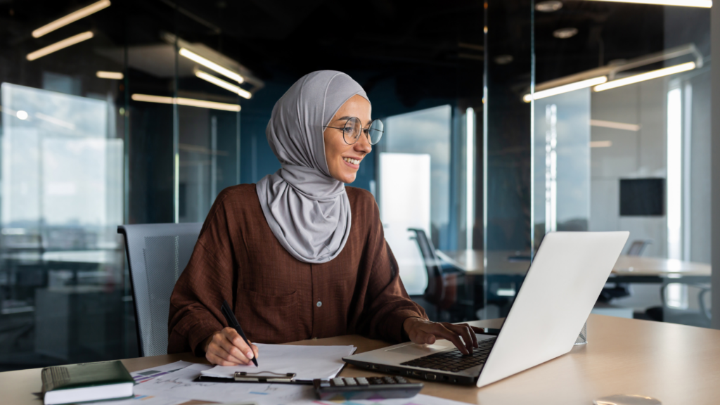 Photo of business woman working on laptop.