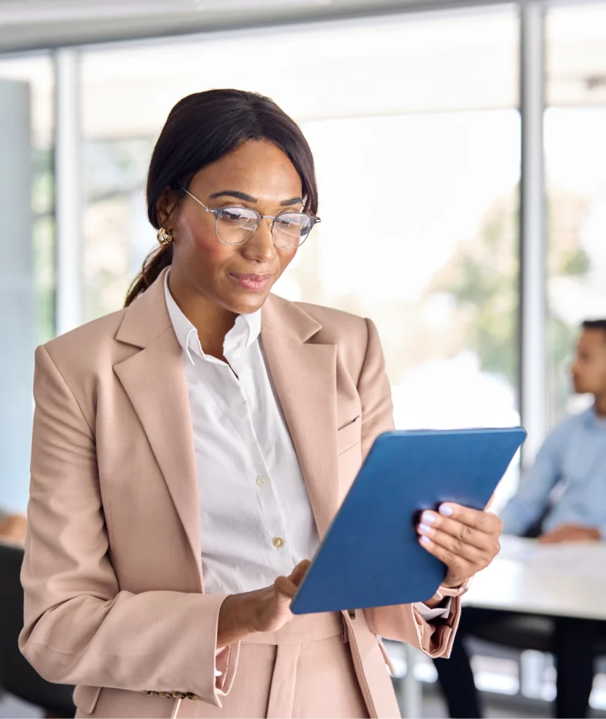 Diverse professional in office setting interacting with technology